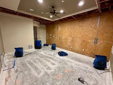 Air movers drying a stripped room down to the slab during a Garden Grove dry-out