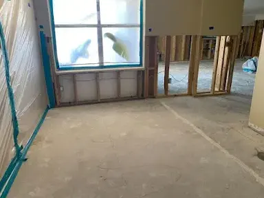 Plastic containment and opened walls during water damage drying in Garden Grove