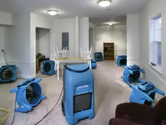 Air movers and an LGR dehumidifier drying a living room in Garden Grove